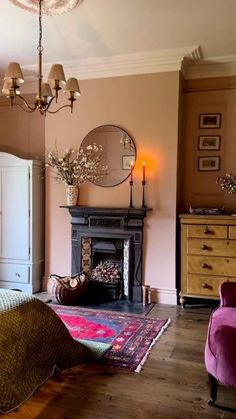 a bedroom with a fireplace, bed and dressers in it's center area