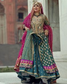 a woman in a green and pink bridal outfit