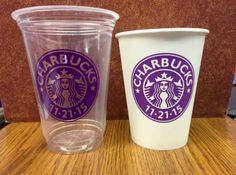 two starbucks cups sitting next to each other on a table