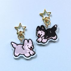 pair of earrings with dog and stars on them