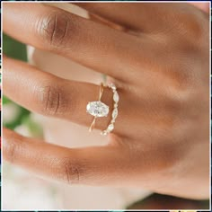 a woman's hand with two rings on it and the ring is made out of pearls