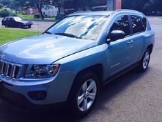 a blue jeep is parked on the street