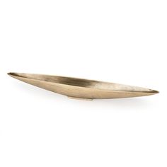 a brass boat shaped dish on a white background