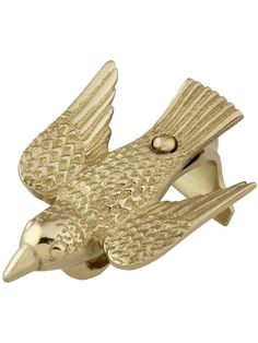 a gold colored bird broochle on a white background