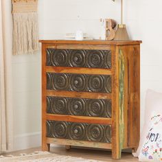 a wooden dresser sitting next to a window