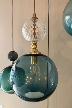 three blue glass lamps hanging from the ceiling