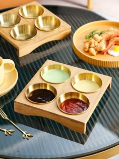 a table topped with different types of condiments and sauces on wooden trays