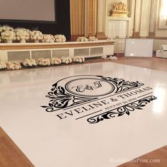 the floor is decorated with flowers and an elegant monogrammed logo for eveline & sons