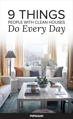 a living room filled with furniture and flowers on top of a coffee table in front of a window