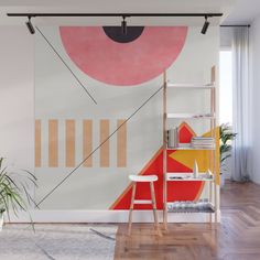 an abstract painting on the wall next to a ladder and chair in front of it