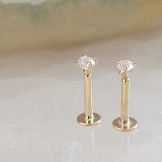 ↘️ Click: "Learn more about this item" for details. Comfortable and easy to wear, these gorgeous diamond CZ studs are set in 14k gold (not plated). Featuring a long tail screw post that makes putting them on super easy! Work, play or sleep, these dainty studs are the perfect everyday accessory. Sold individually or as a pair. * T H E * D E T A I L S *  * Solid 14K Gold, choose form yellow or white * Cubic Zirconia measures 2mm * Post measures 18 gauge and 6mm long * Thoughtfully packaged & ready Internally Threaded 14k Gold Wedding Earrings, 14k Gold Internally Threaded Earrings For Wedding, Gold Cartilage Earrings With Prong Setting For Wedding, Gold Cartilage Earrings For Wedding With Prong Setting, Screw Posts, White Jewelry Box, Easy Work, Dainty Studs, White Jewelry