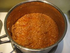 a metal pot filled with food sitting on top of a stove