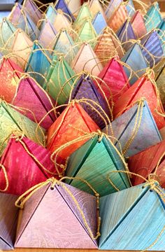 many colorful kites are tied together and ready to be put into the box for display