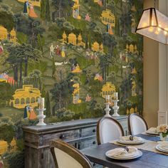 a wallpapered dining room with a table and chairs