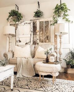 a living room filled with lots of furniture and plants on top of it's walls