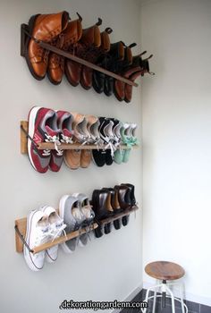 several pairs of shoes are hanging on the wall