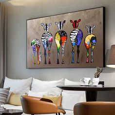 three zebras are painted on a wall above a couch in a living room with two chairs