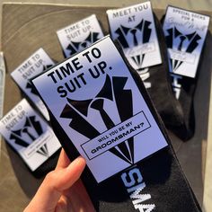 someone is holding up a sticker that says time to suit up, while other stickers are in the background