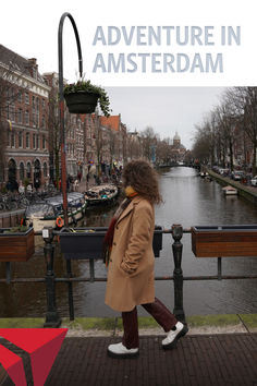 a woman walking down a street next to a river