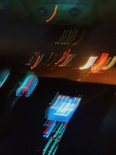 the interior of a car is lit up with colorful lights and blurry objects in the background