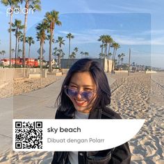 a girl wearing sunglasses on the beach with palm trees in the background