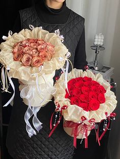 the woman is holding two large bouquets of roses