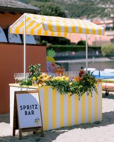 a yellow and white striped bar on the beach