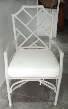 a white chair sitting on top of a tiled floor