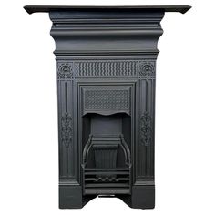 a black fireplace with an ornate design on the top and bottom part, against a white background