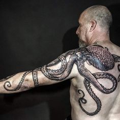 an old man with tattoos on his arm and chest