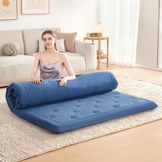 a woman is sitting on an inflatable mattress