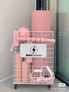 a pink hair dryer sitting on top of a metal basket