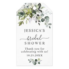 a white and green floral bridal shower sign with greenery on the bottom,