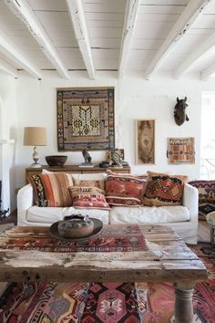 a living room filled with lots of furniture and rugs