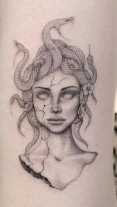 a woman's face with a snake on her head