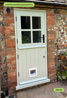 a dog door is open on the side of a brick building with potted plants