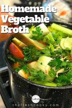 a pot filled with vegetables sitting on top of a stove