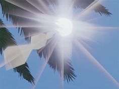 the sun shines brightly through palm trees on a clear day in the blue sky