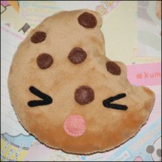 a close up of a stuffed animal with chocolate chip cookies on it's face