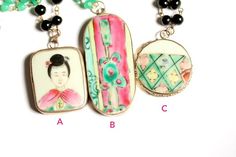 Old pottery shard pendants appear to be from the same vase, set in sterling silver. Choose from ONE of THREE styles: A portrait pendant - 1 1/2" long x 1 1/4" wide pendant - 16" black glass bead chain B long oval - 2 1/2" long x 1 1/4" wide pendant - 18" jade green glass bead chain C round pendant - about 1 1/2" across pendant - 24" black bead chain CONTACT ME Sign up for shop coupon codes, new and old-school jewelry designs, new limited edition & vintage listings in the shop, and jewelry & fashion history: minusOnejewelry.com/contact (I send an email every other week.) Visit my blog: minusOnejewelry.com/blog. Find me on Instagram and Facebook: minusOneJewelry Re-enter my shop here: minusOne.etsy.com Stay and buy yourself something nice. Artisan Green Hand Painted Necklace, Green Hand Painted Artisan Necklace, Vintage Hand Painted Round Pendant Necklace, Chinese Necklace Pendants, Vintage Hand-painted Pendant Necklace, Old Pottery, School Jewelry, Chinese Pottery, Black Bead Necklace