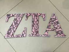 the letters are made out of pink and black fabric