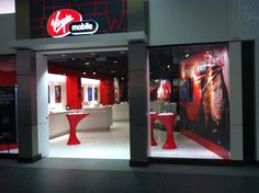 the inside of a mobile store with red and white accents