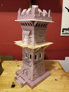 a paper model of a tower on top of a wooden table