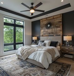 a bedroom with a large bed and ceiling fan