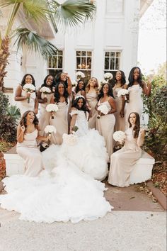 the bridesmaids are posing for a photo in front of their wedding venue,