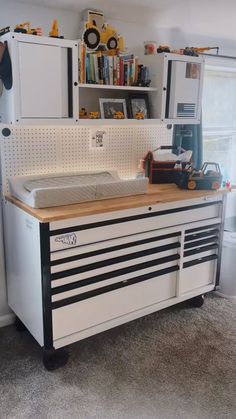 a workbench with lots of tools on top of it in a room filled with toys