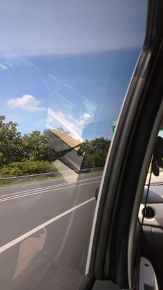 the view from inside a car looking at trees