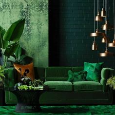 a living room filled with green furniture and plants