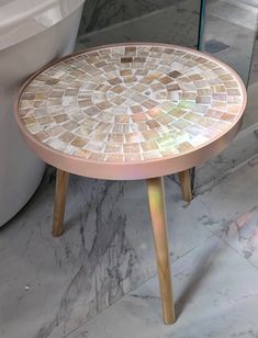 a small table sitting on top of a bathroom floor