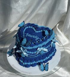 a blue cake with butterflies on it